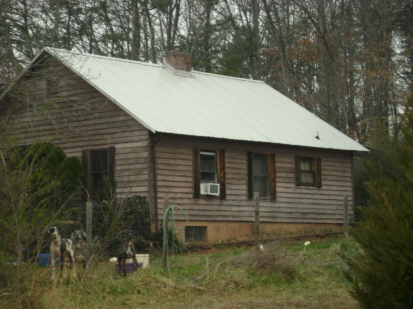 White metal roof on an old wood sided farmhouse, from a Metal Roof Installation job in Kinards